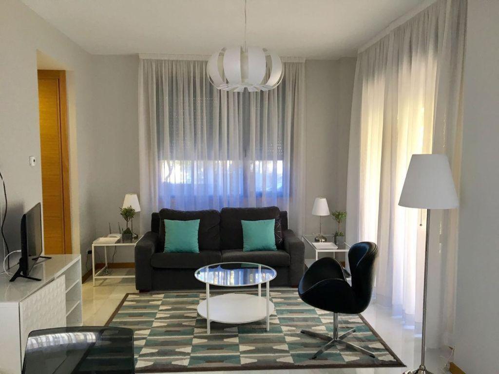 ein Wohnzimmer mit einem Sofa, einem Tisch und Stühlen in der Unterkunft Maravilla del Castro in Vigo
