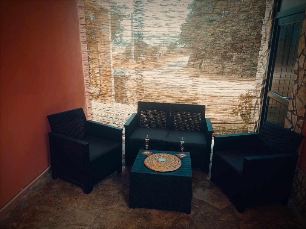 a living room with two chairs and a table at Apartman MR in Potpićan