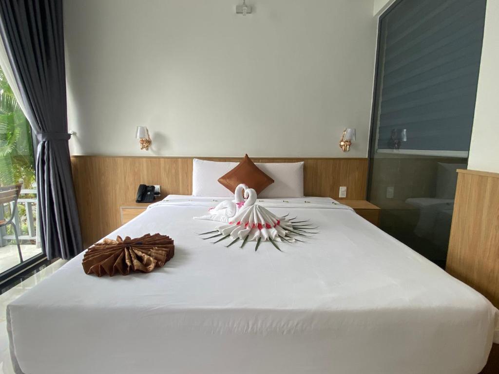 Postel nebo postele na pokoji v ubytování Ngoc Trai Xanh Bungalow