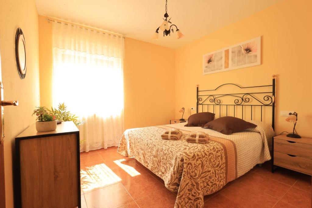 a bedroom with a large bed and a window at La Resbalina de Arribes in Trabanca