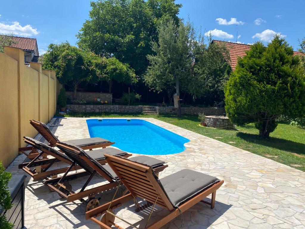 a group of chairs and a swimming pool at Apartment Gemer & Volovec in Rožňava
