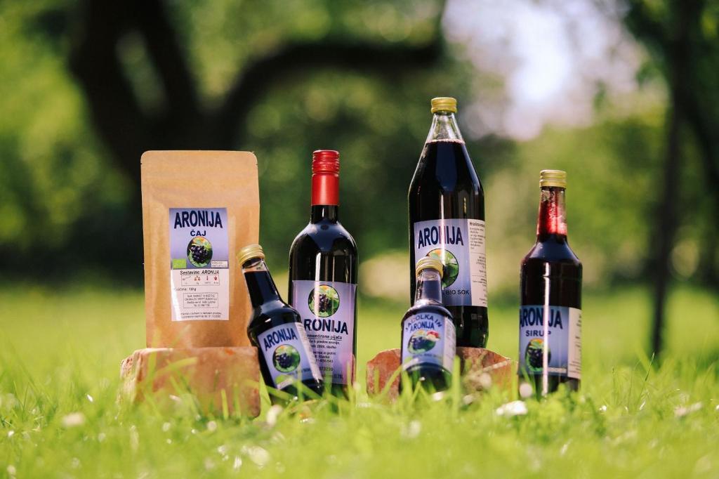 a group of four bottles of wine sitting in the grass at Bed and Breakfast Kreft in Ljutomer