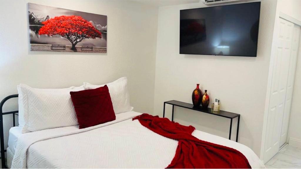 a bedroom with a bed with a red blanket on it at Cozy Studio…5 min away from LAS Airport. “ in Las Vegas