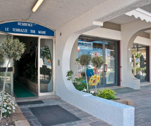a store front with a sign on the side of a building at Residence Le Terrazze Sul Mare in San Mauro a Mare
