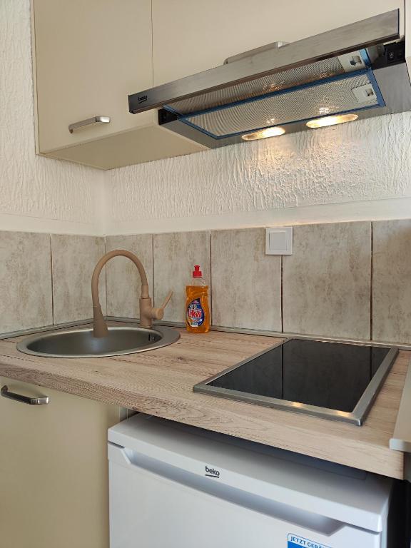 a kitchen with a sink and a counter top at MM Apartments in Budva