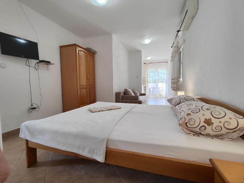 a bedroom with a large white bed in a room at MM Apartments in Budva
