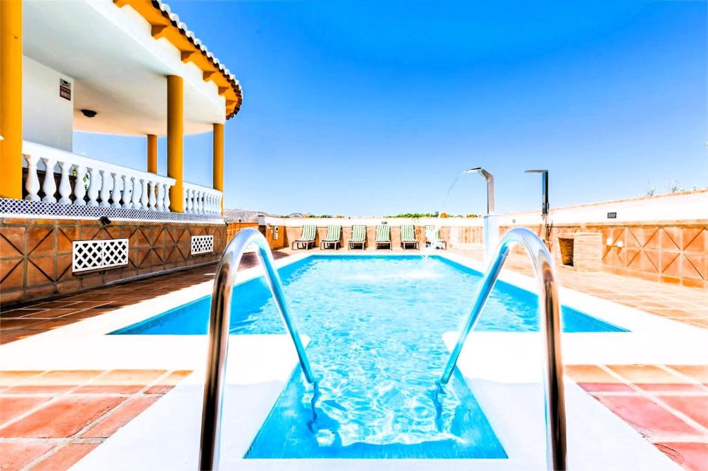 a swimming pool on the roof of a house at CASA RURAL VILLAMAYNO in Alcaucín