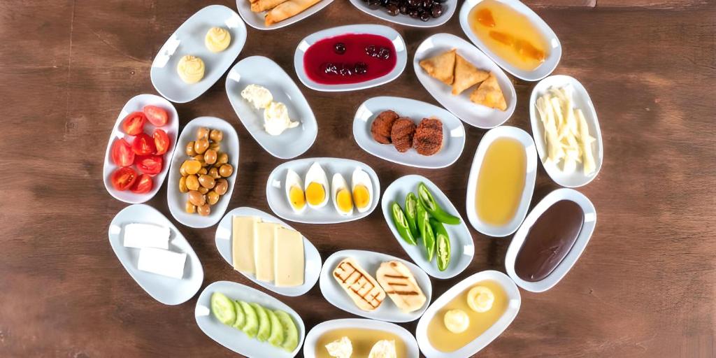 a table with many plates of food on it at Osmanlı Suite Airport in Trabzon