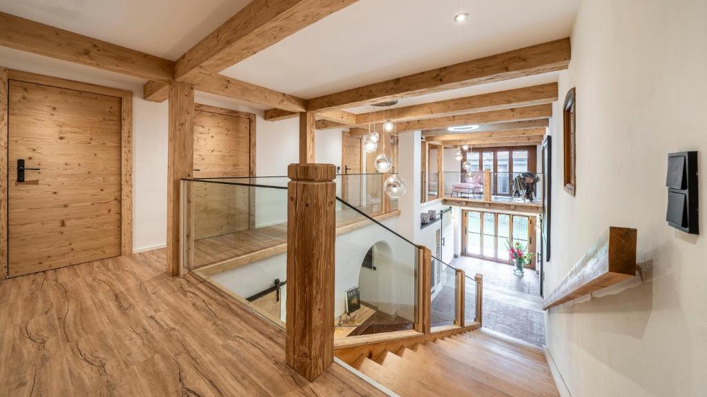 a large room with a glass staircase and wooden walls at Der Weberhof/Pension Willibald in Bad Tölz