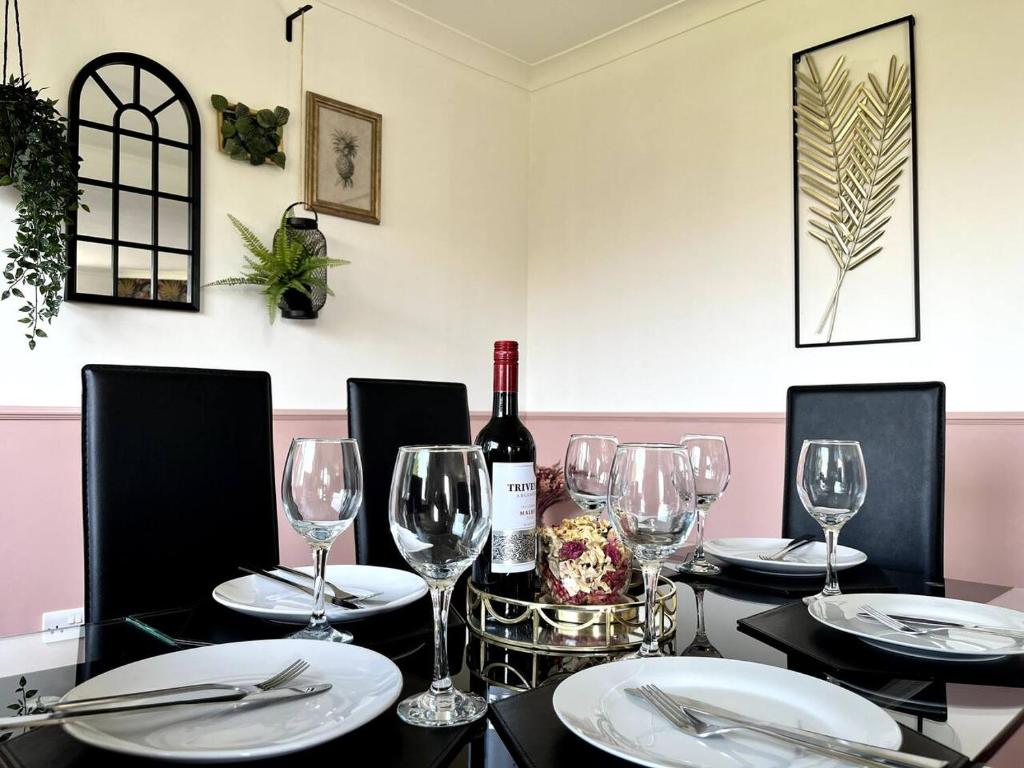 a table with a bottle of wine and glasses at Lake view Pet Friendly parking golf nearby in Bowness-on-Windermere