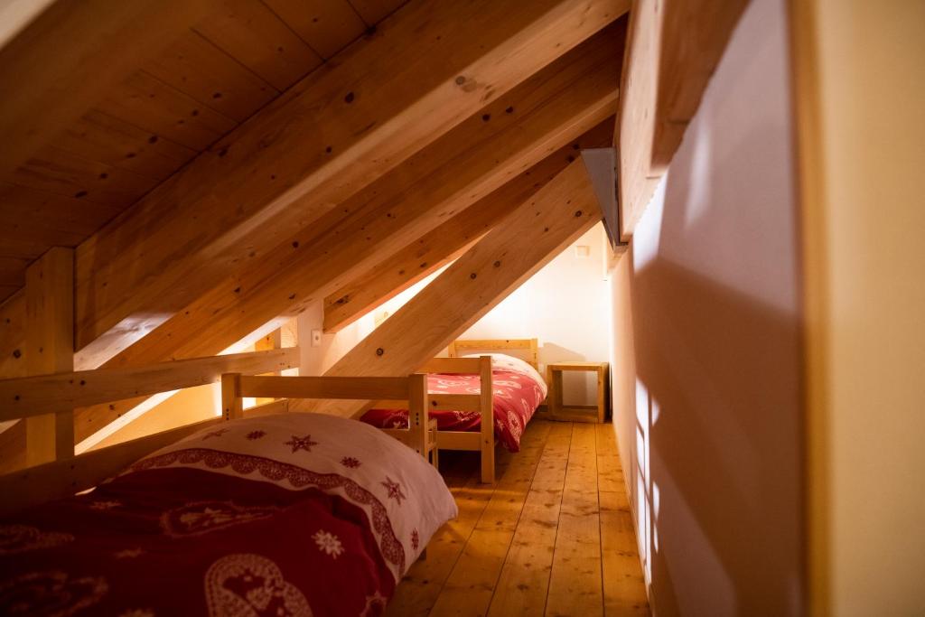 a room with two beds in a attic at Aiguille de La Tza in Arolla