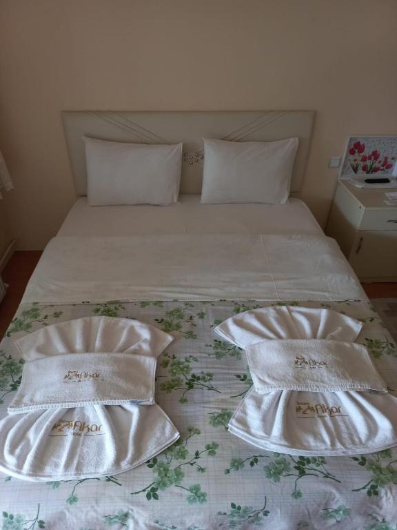 A bed or beds in a room at Akar Hotel