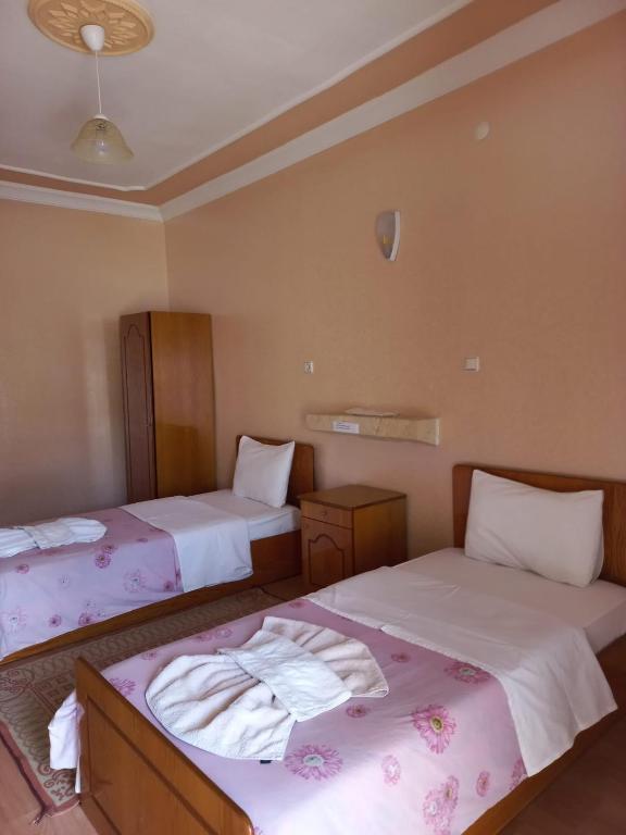 A bed or beds in a room at Akar Hotel