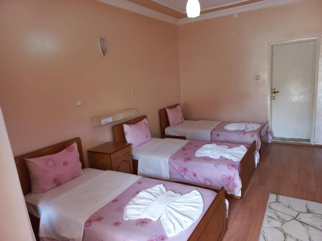 A bed or beds in a room at Akar Hotel