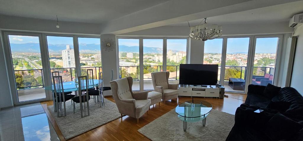a living room with a view of a city at Mr.-Legend's Penthouse in Skopje
