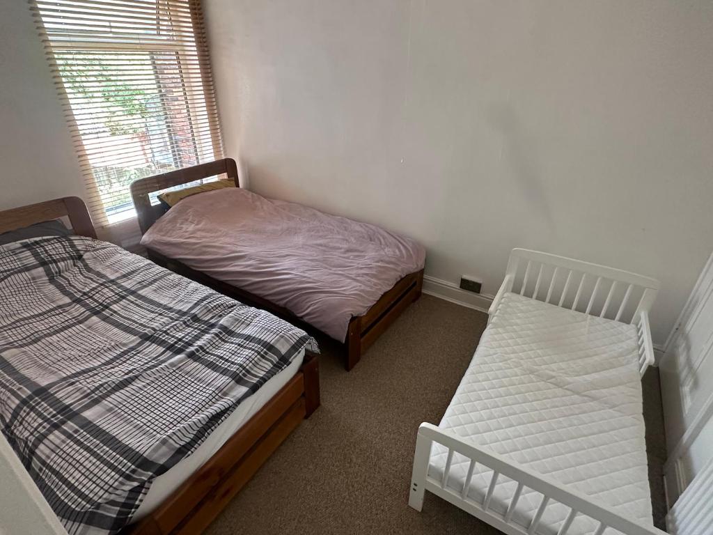a bedroom with two beds and a window at Daniel’s Semi Rural Retreat in Clowne