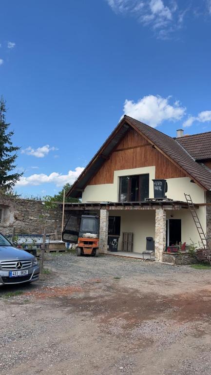 a house with a car parked in front of it at Motoráj -apart Kutná Hora in Kutná Hora