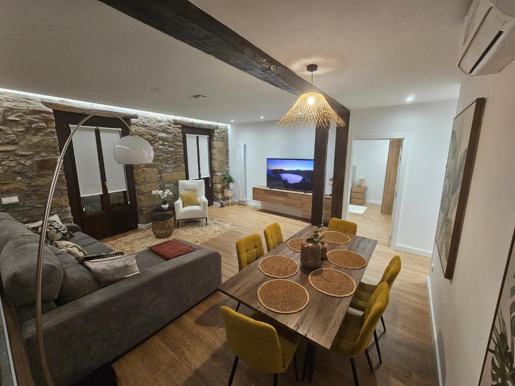 a living room with a table and a couch at Brand new Port Relax with AC by Santiago in San Sebastián