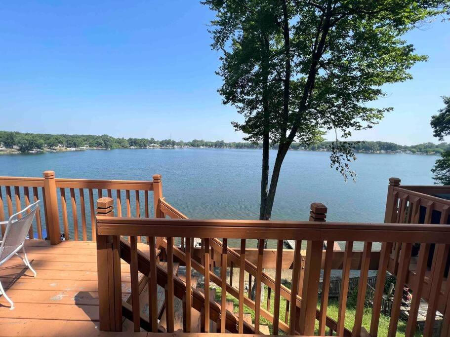 a wooden deck with a view of a lake at Lakin' It Easy in Middlebury