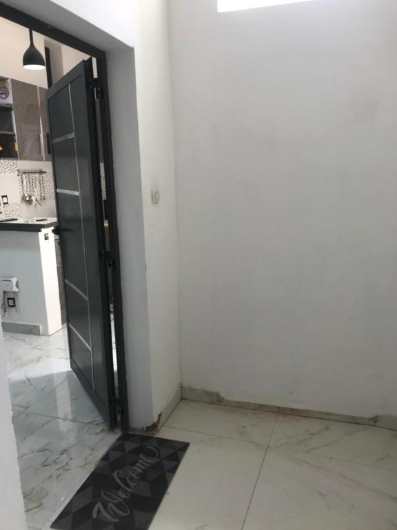 an open door to a kitchen with a refrigerator at STUDIO MEUBLE DAKAR Suite 1 in Dakar