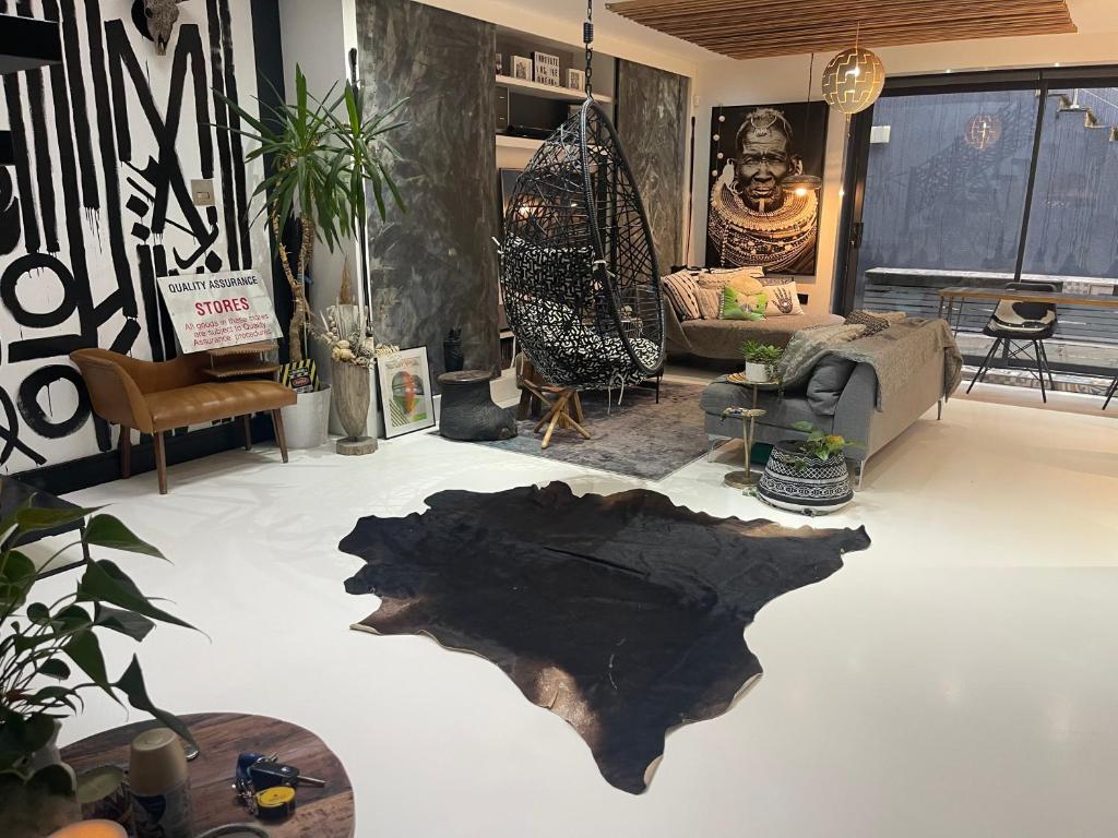 a living room with a large rug on the floor at Unique and Artsy Holiday Shared Home in Purley