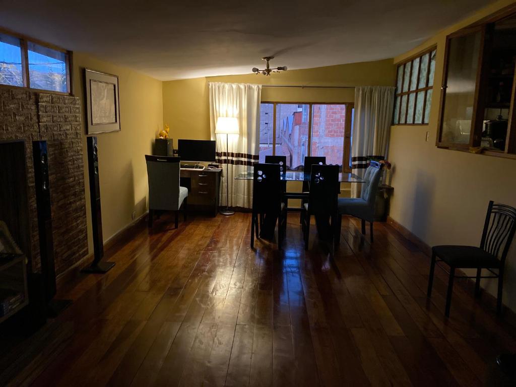 a living room with a dining room table and chairs at MY WAY Apartment in Cusco