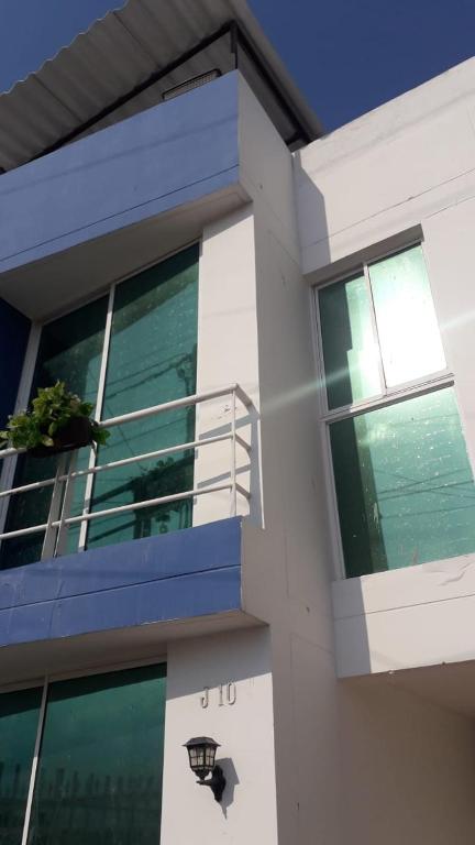 a building with a balcony with a potted plant on it at Casa Amplia Completa Privada para Familias in Santa Marta