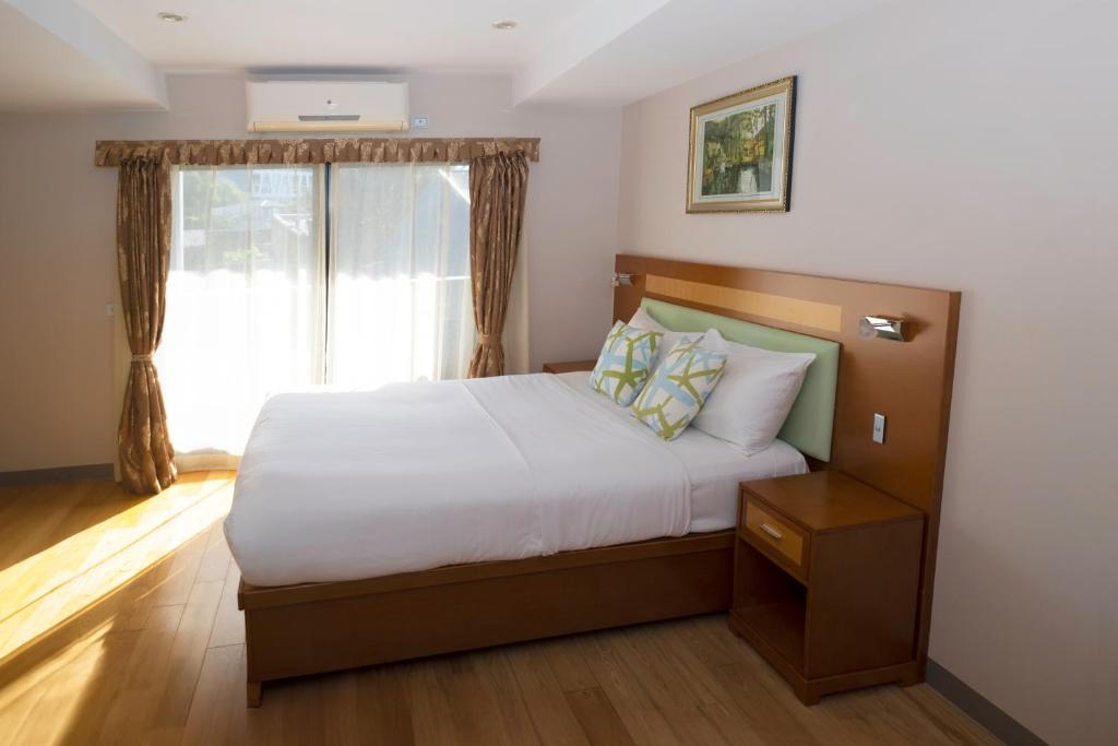 Postel nebo postele na pokoji v ubytování Melrose Apartments