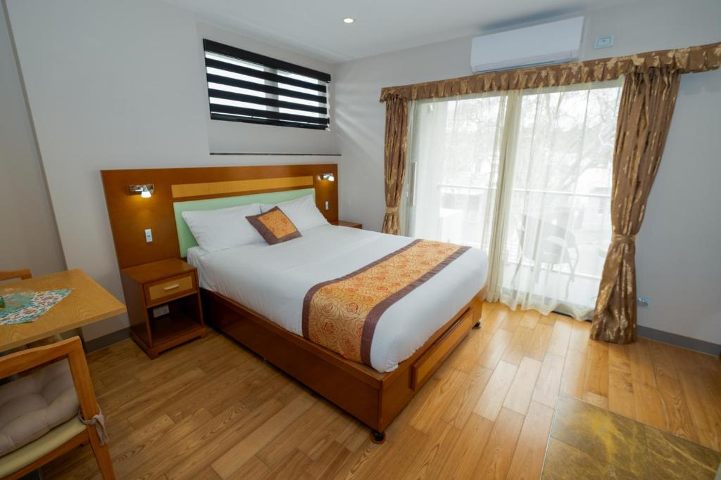 Postel nebo postele na pokoji v ubytování Melrose Apartments