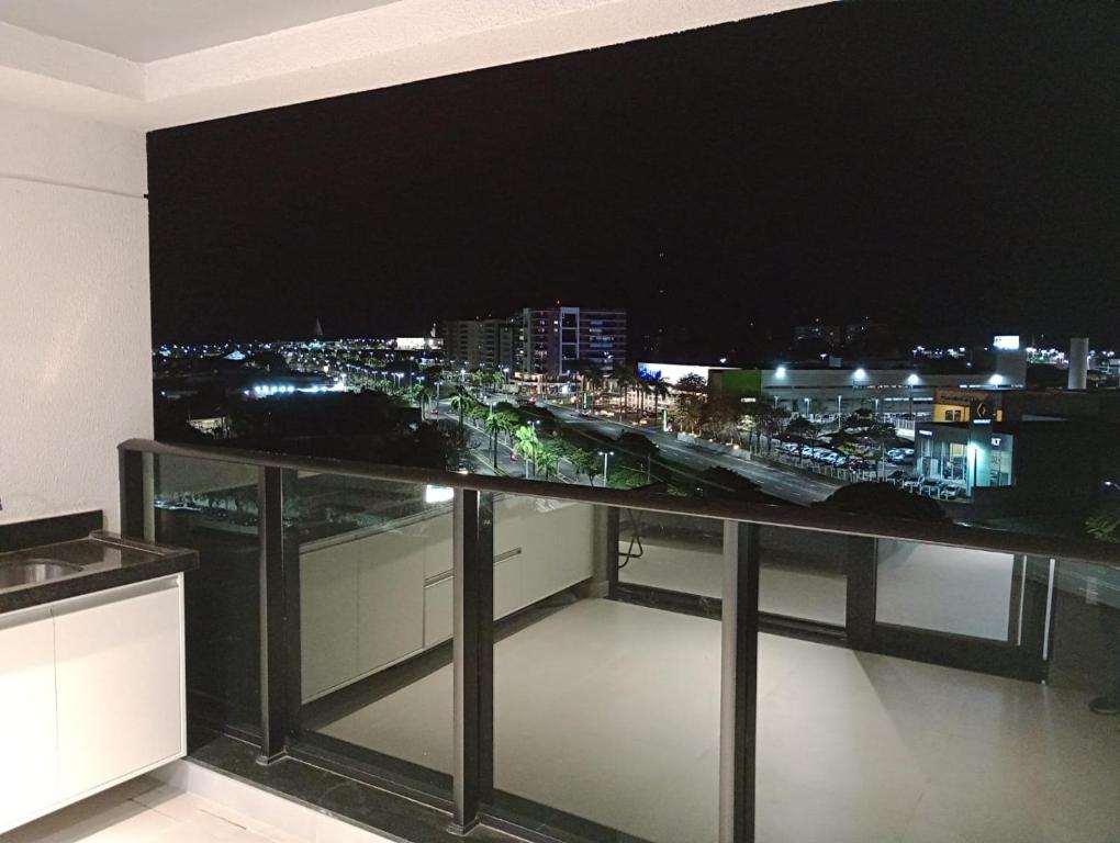 a room with a view of a city at night at Studio 811 in Marília