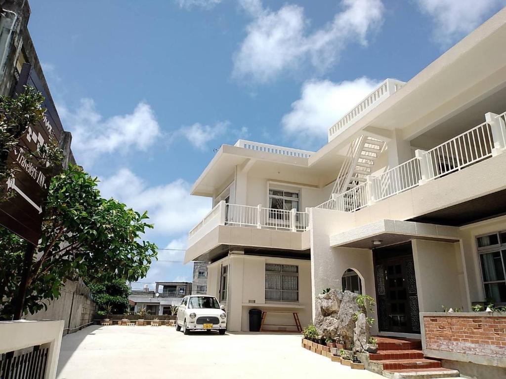 a white van parked in front of a building at フェーヌカジ洋室 in Miyako-jima