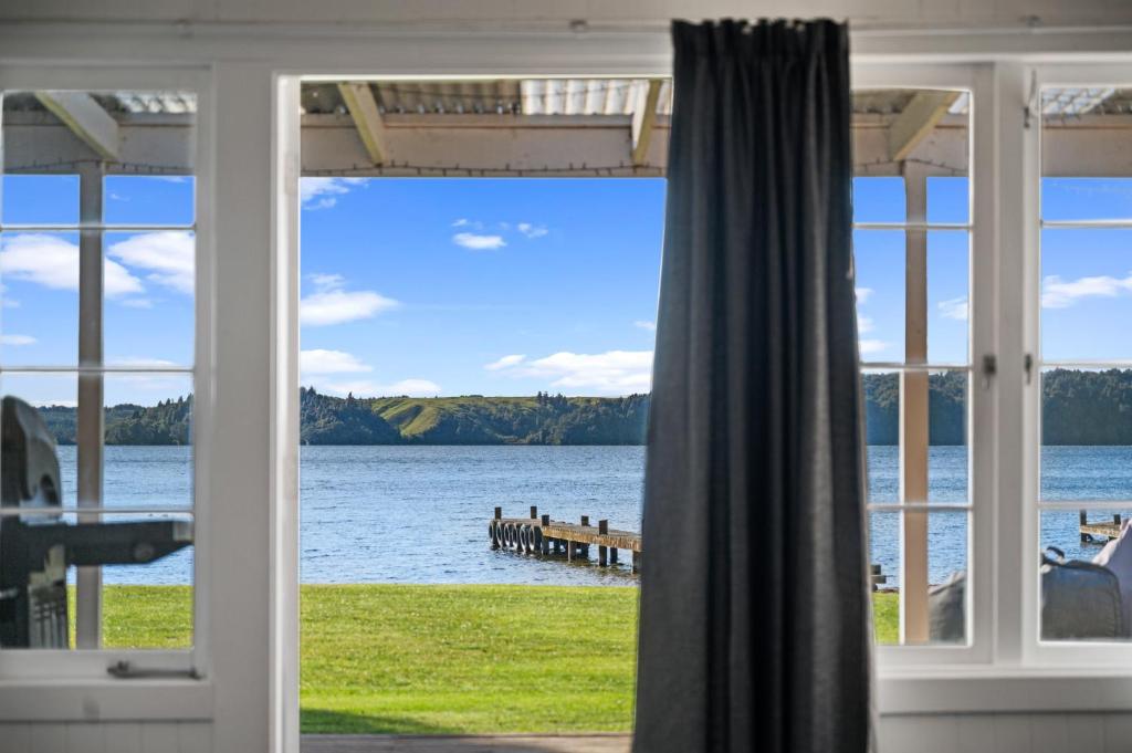 a view of the water from a house window at The Middle in Rotoiti