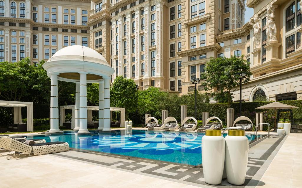 a swimming pool with a gazebo and a building at THE KARL LAGERFELD in Macau