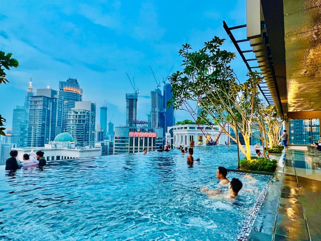 a swimming pool with a city skyline in the background at AXON Suites Bukit Bintang By Sky Pool in Kuala Lumpur