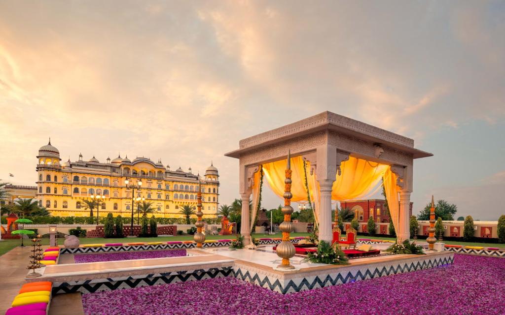 a hotel with a gazebo in front of a building at Noormahal Palace Hotel in Karnāl