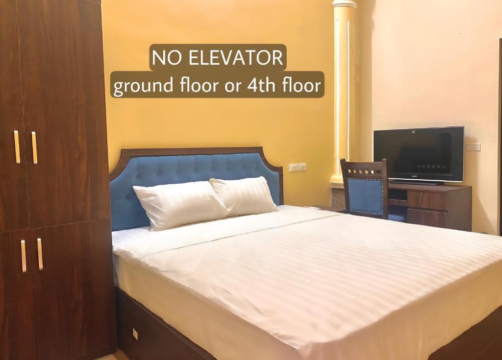 a bedroom with a bed with a no elevator ground floor or floor at Hanoi Hidden Guest House in Hanoi