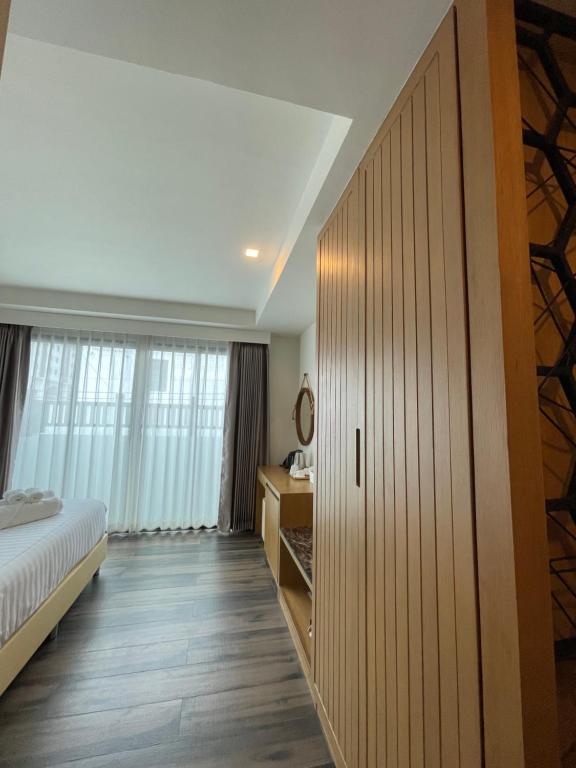 Postel nebo postele na pokoji v ubytování Baannalin Hometel บ้านนลิน โฮมเทล