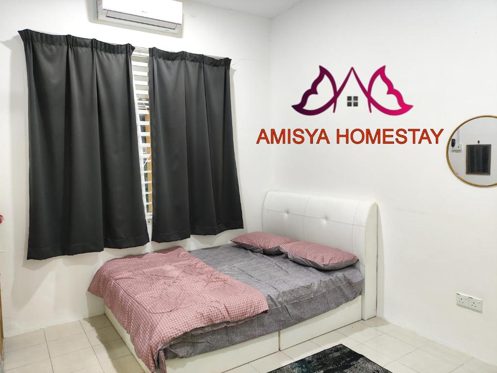 A bed or beds in a room at Amisya Homestay