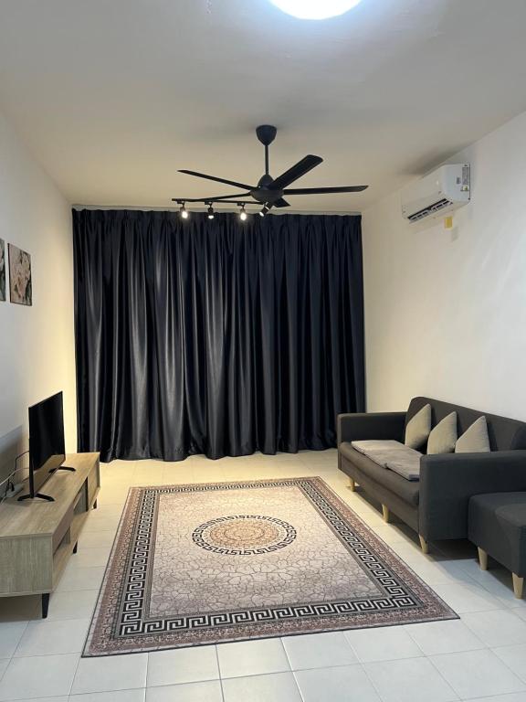 a living room with a couch and a ceiling fan at Residensi Afamosa in Kampong Alor Gajah