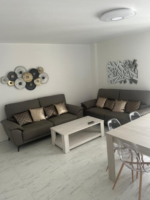 a living room with a couch and a table at 5 minutes à Pied du Stade De France in Saint-Denis