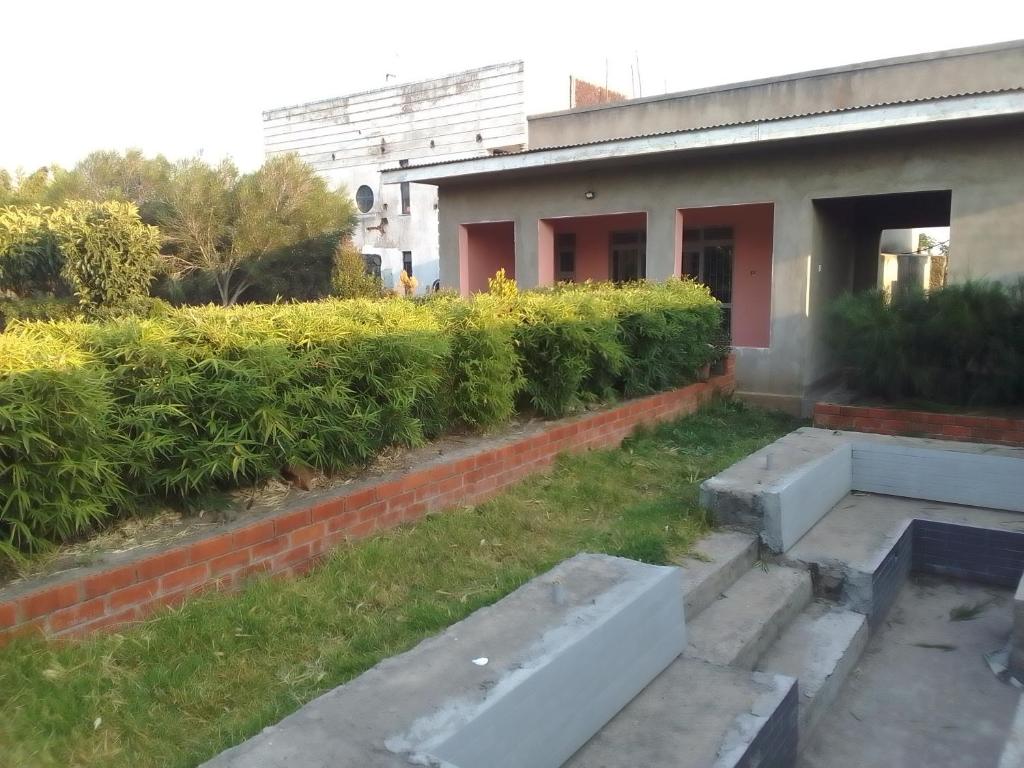 a building with concrete steps in front of a yard at AGASARO ECO RESORT 