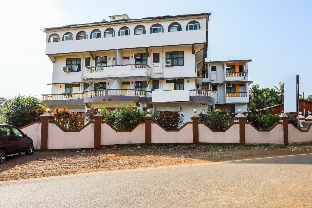 a building with a fence in front of it at Hotel Priti International in Mapusa