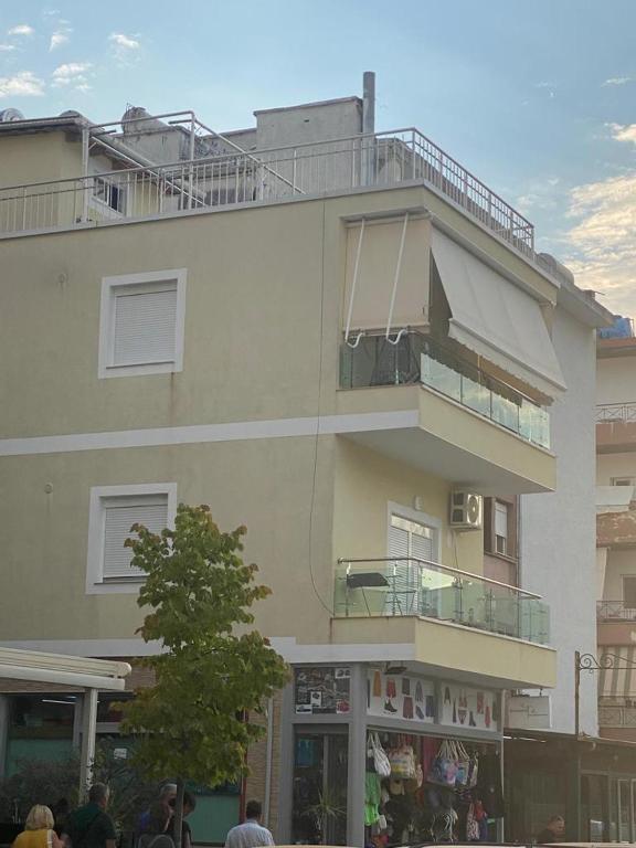 a building with people standing outside of it at Apartment Alexis Stefanos in Himare