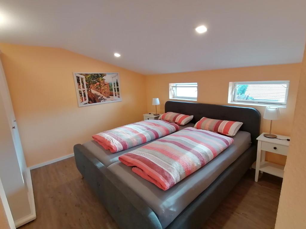 a bed in a room with two pillows on it at Casa Mediteran NEU in Reichensachsen