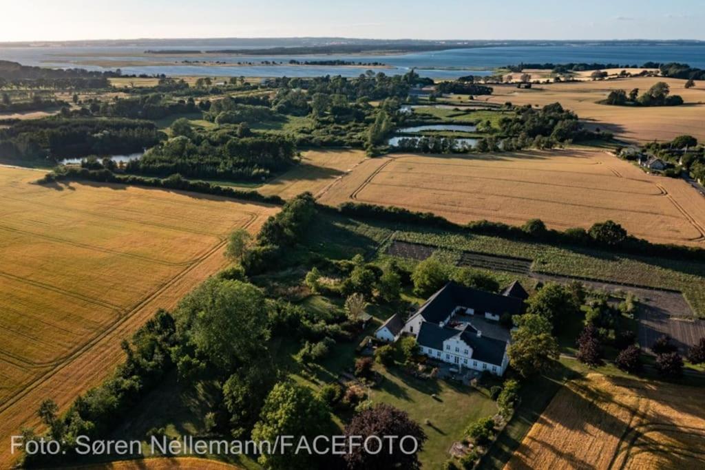 an aerial view of a house and a field at Fuglsanggaard. Private annex in nature. in Præstø