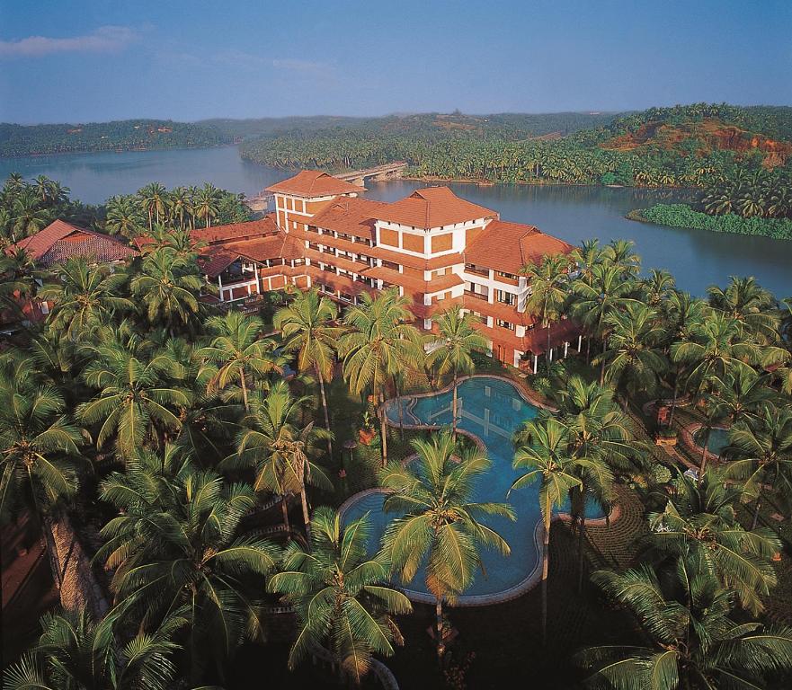 una vista aérea de un complejo con palmeras y piscina en The Raviz Kadavu, Kozhikode, en Kozhikode