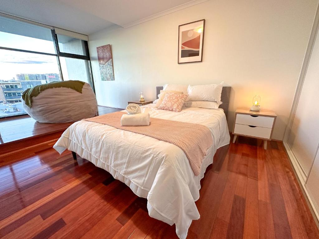 a bedroom with a bed and a large window at Convenient 2BR in Marrickville in Sydney