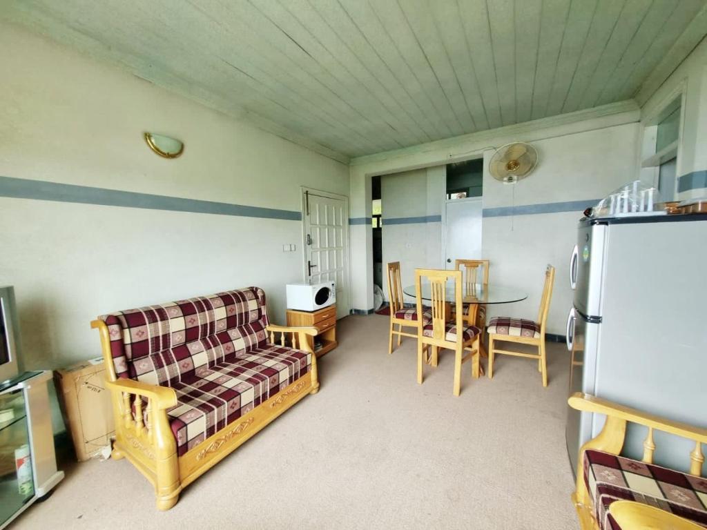 a living room with a couch and a table at Bird's Nest in Bhurban