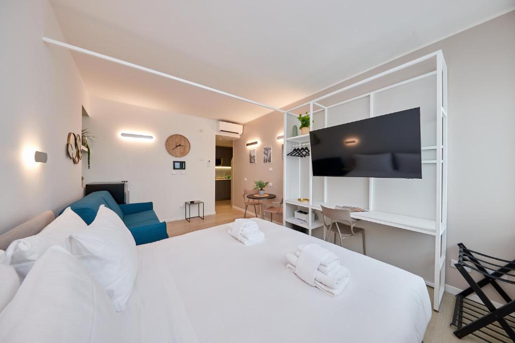 a bedroom with a large white bed and a desk at Gioia 55 in Milan