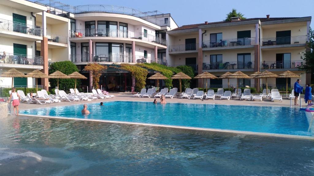 a swimming pool in front of a hotel at Nettuno Residence Hotel in Peschiera del Garda